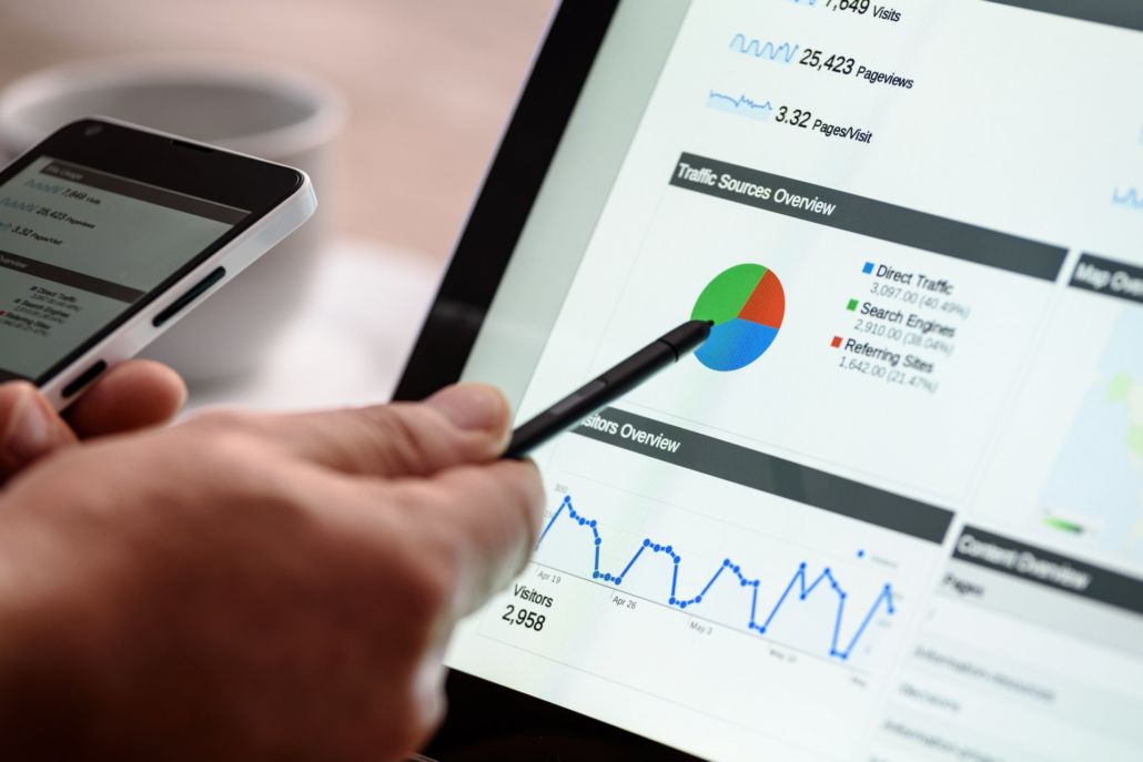 Web Designers taking SEO into consideration Web Designers looking at SEO statistics and pointing at a pie chart