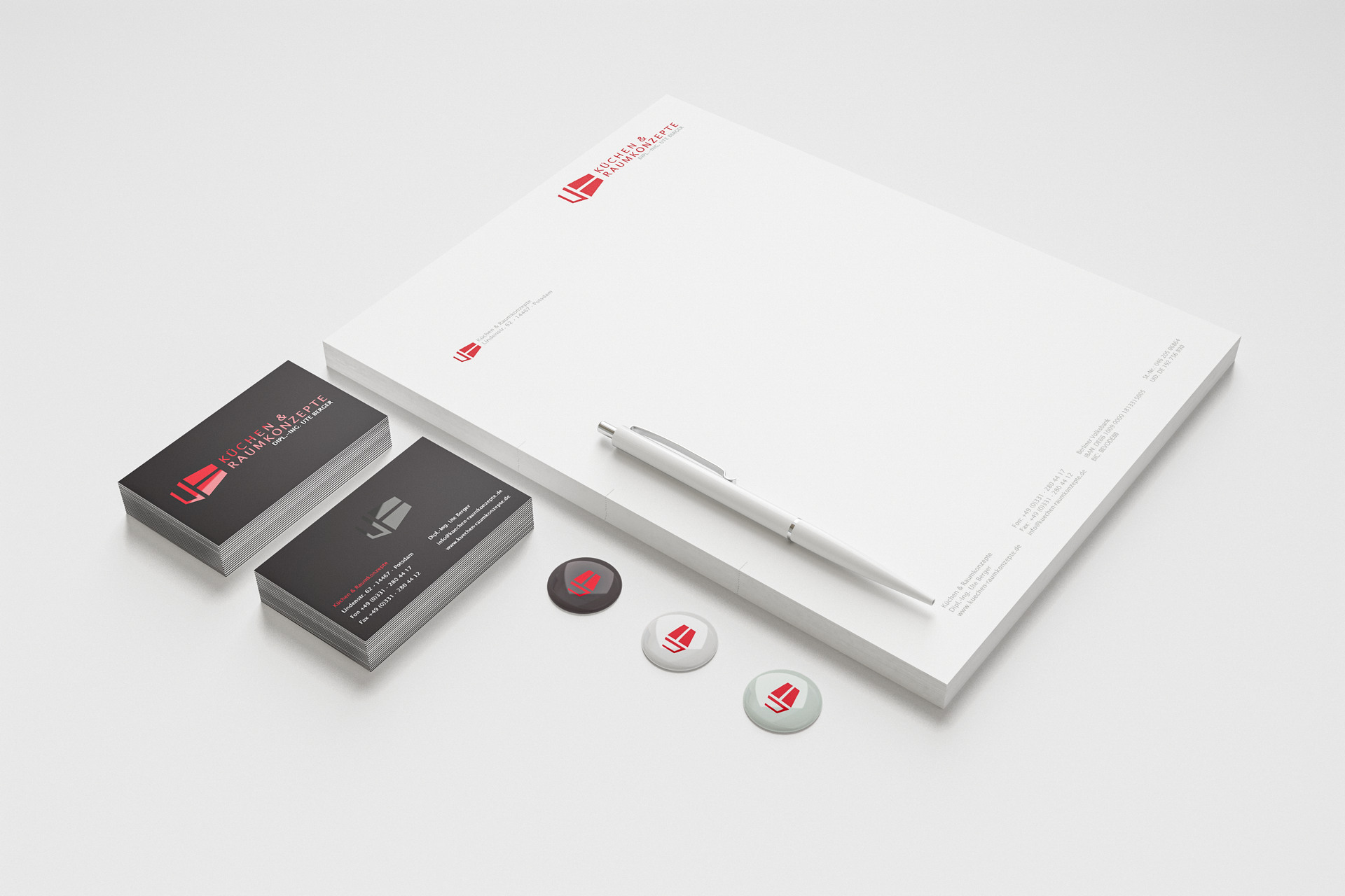 Corporate design shown on business paper, cards and buttons