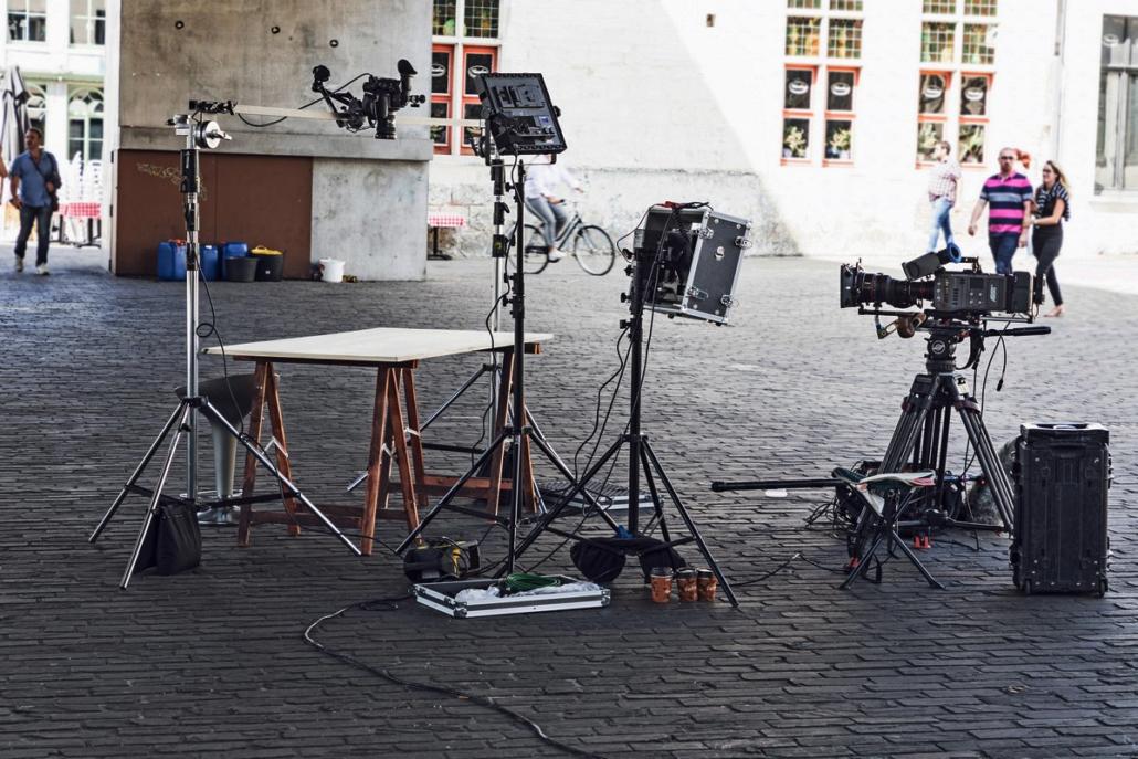 The film production company berlin decorated this product video set outside, showing video euquipment in the shade on a public street with walking people in the background