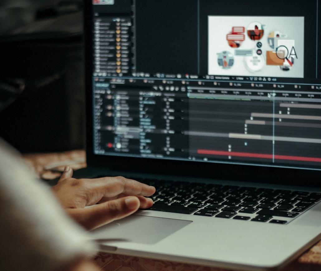 We see a laptop that is being used to work with the Adobe After-Effects program. In the crop on the left, the motion graphic designer is pictured and we see his left hand on the laptop.