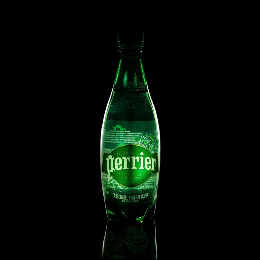 Have a product video created for mineral water. As an example, this image shows a bottle of Perrier mineral water with a green label in front of a black background. The scene is illuminated low-key and the light is reflected in the bottle in an impressive way.