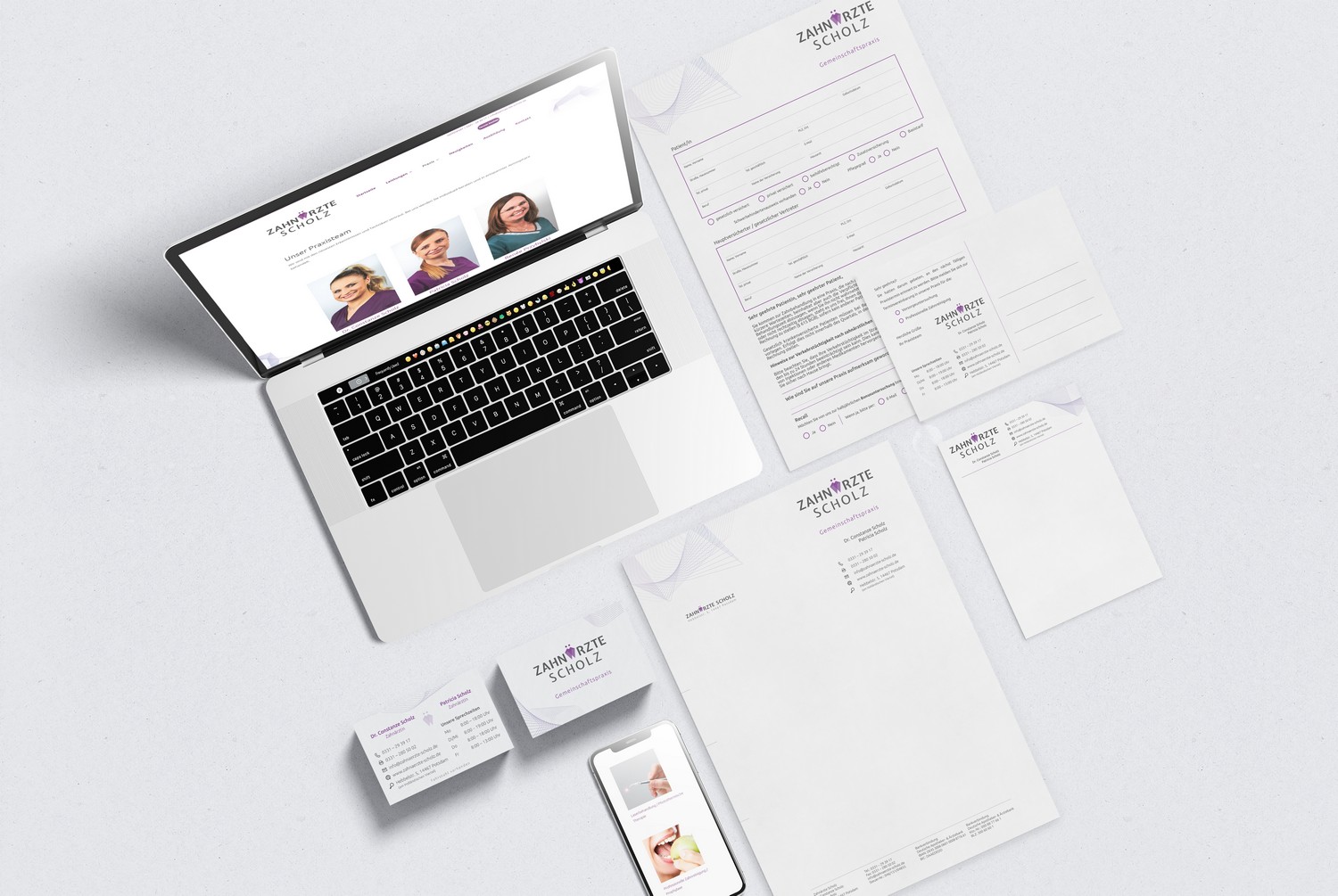 Brand new marketing and business material including new website created by a web design company for dentists, as shown in this perspective view: You can see a laptop with the new website next to various documents, which also shine in fresh corporate identity.