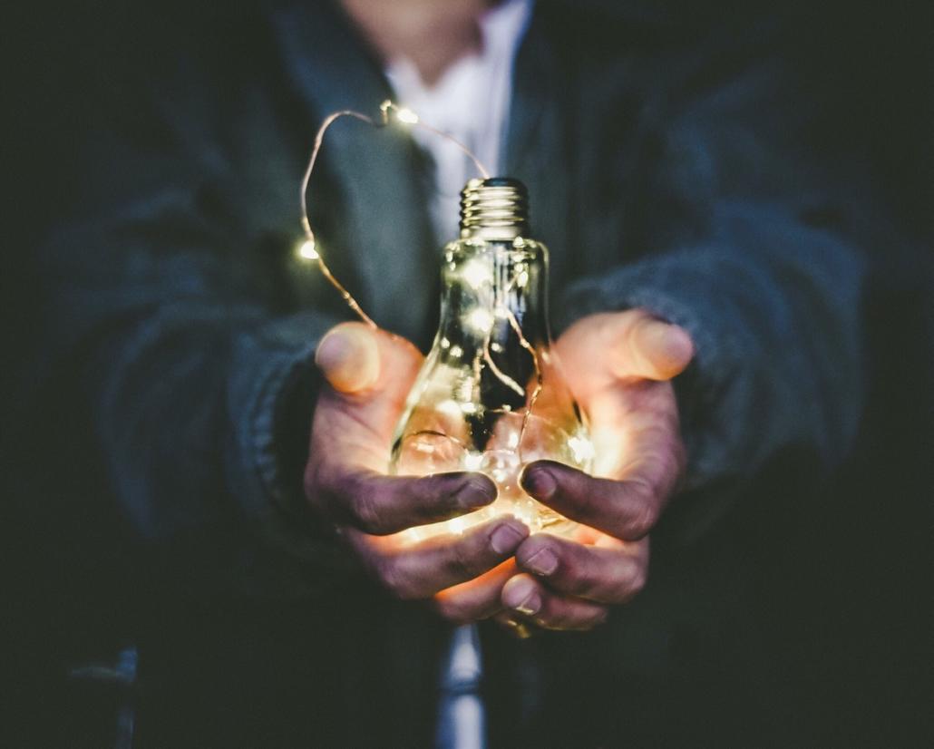 If you want to make an animated video explainer, it can make sense to use real film, as illustrated here by this image: it shows a close-up of a man's hands holding a luminous light bulb.